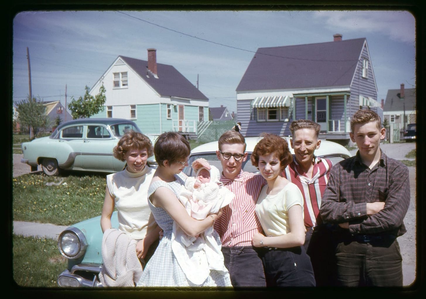 A family gathering with a baby in arms.