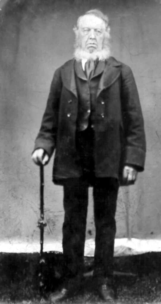 Elderly gentleman with a cane and a long white beard