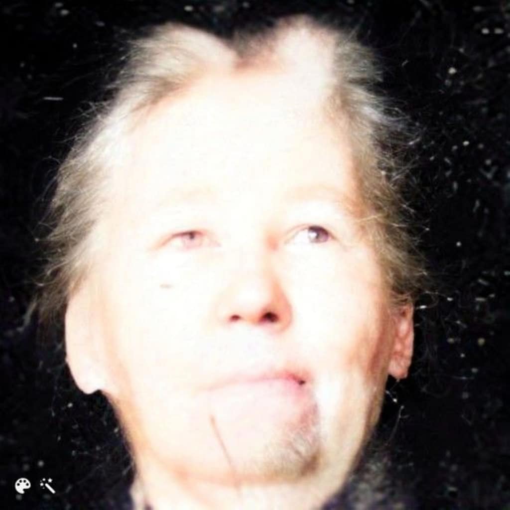 Picture of a woman with white hair looking up.