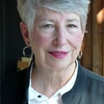 Portrait of a woman with grey hair and young looking.