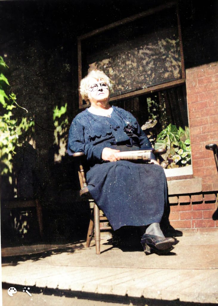 My grandmother Louise sitting in a rocking chair on her porche.