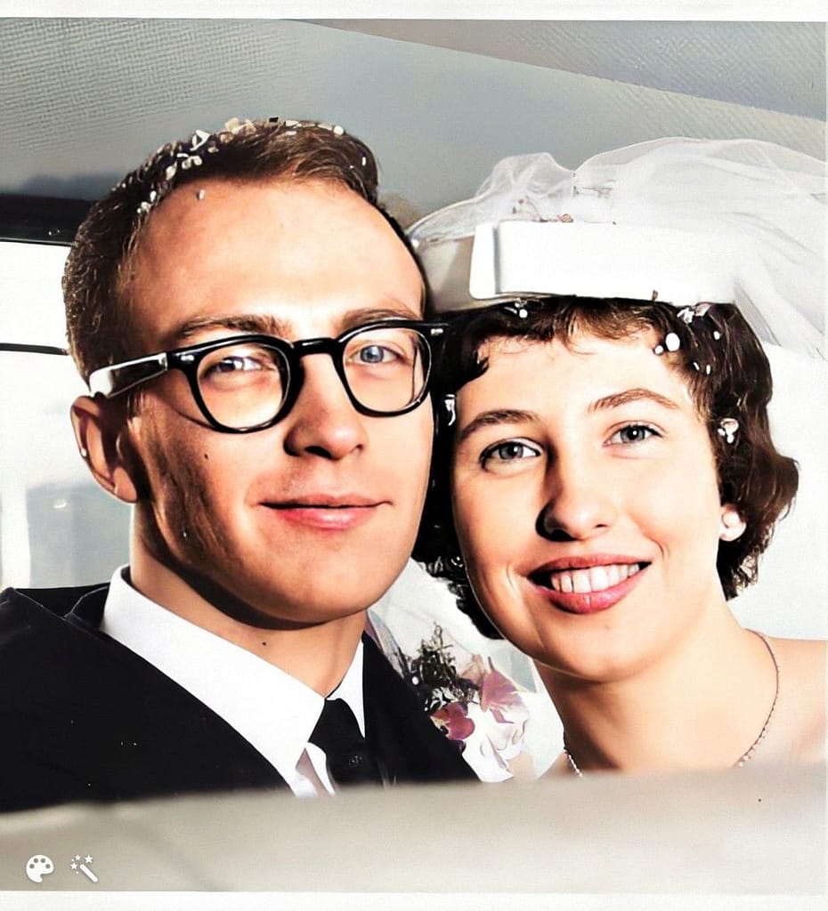 Heads of bride and groom being photographed in a car.