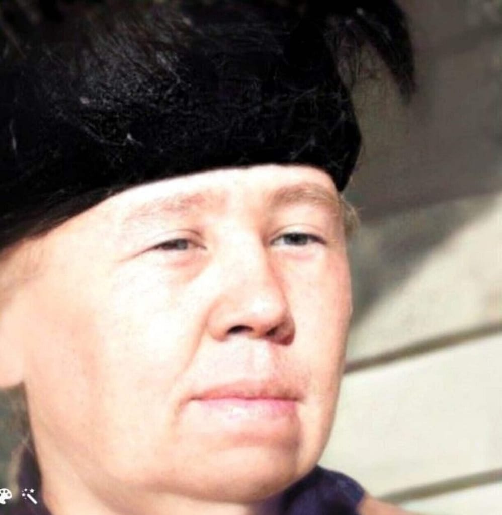 A woman with a black hat. Just a head view.