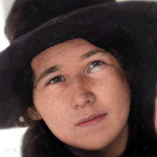 Young woman with a big brimmed hat on.