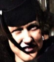 A woman with a black hat with a feather.