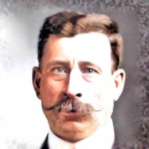 Headshot of a male with red hair on his head and a red mustache.